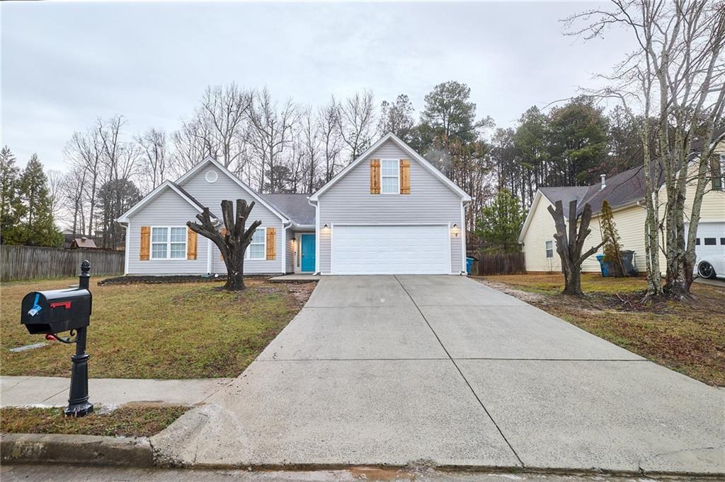 1645 Fort Mason Way Dacula, GA 30019 - Photo 2 of 28 a front view of a house with a yard and garage