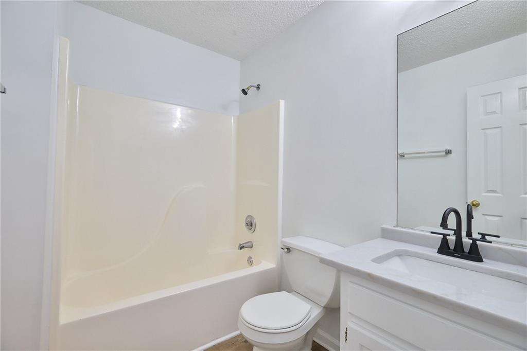 1645 Fort Mason Way Dacula, GA 30019 - Photo 23 of 28 a bathroom with a sink a toilet and a bathtub