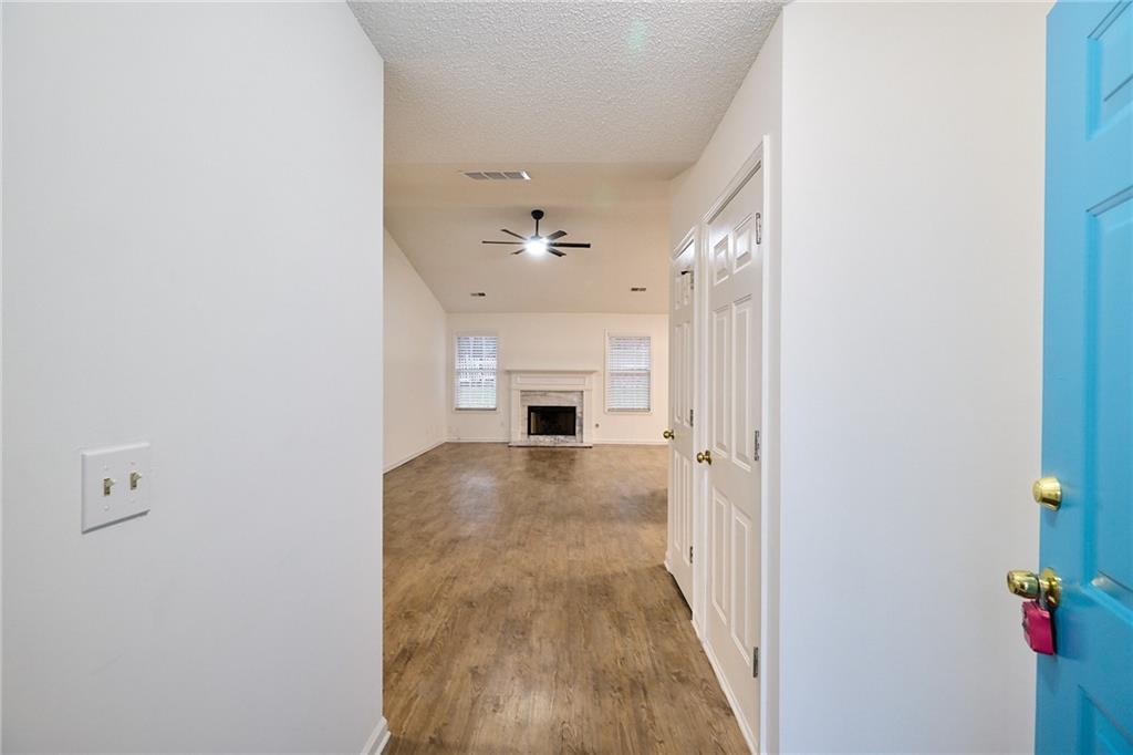 1645 Fort Mason Way Dacula, GA 30019 - Photo 4 of 28 a view of a hallway to a livingroom with a fireplace