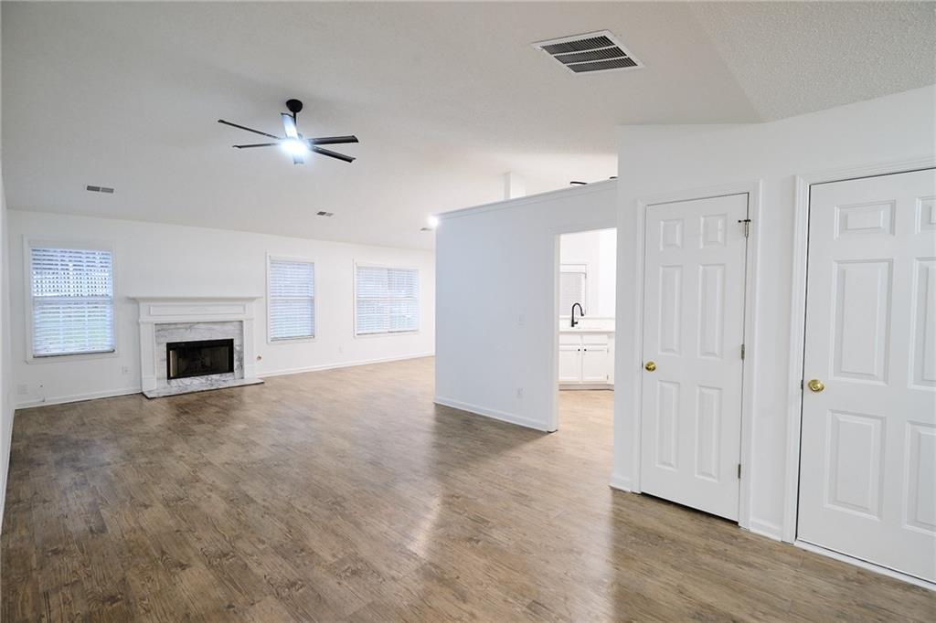 1645 Fort Mason Way Dacula, GA 30019 - Photo 5 of 28 a view of an empty room with a fireplace and a window