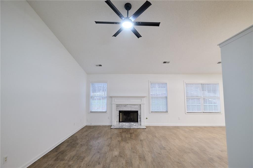 1645 Fort Mason Way Dacula, GA 30019 - Photo 6 of 28 a view of an empty room with window and fireplace