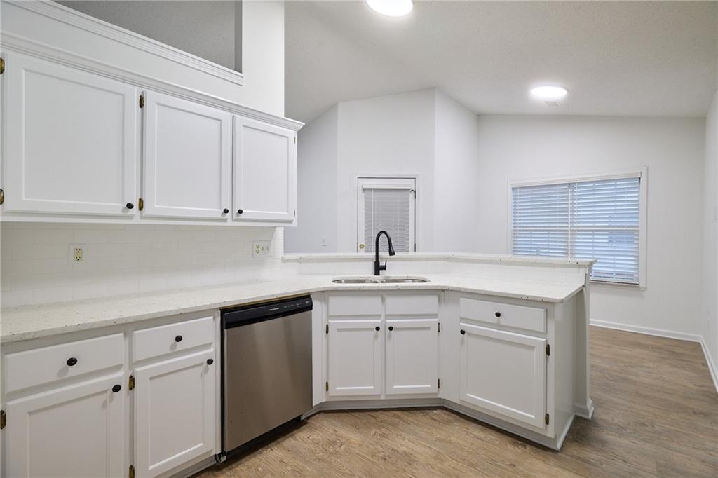 1645 Fort Mason Way Dacula, GA 30019 - Photo 10 of 28 a kitchen with white cabinets appliances a sink and dishwasher