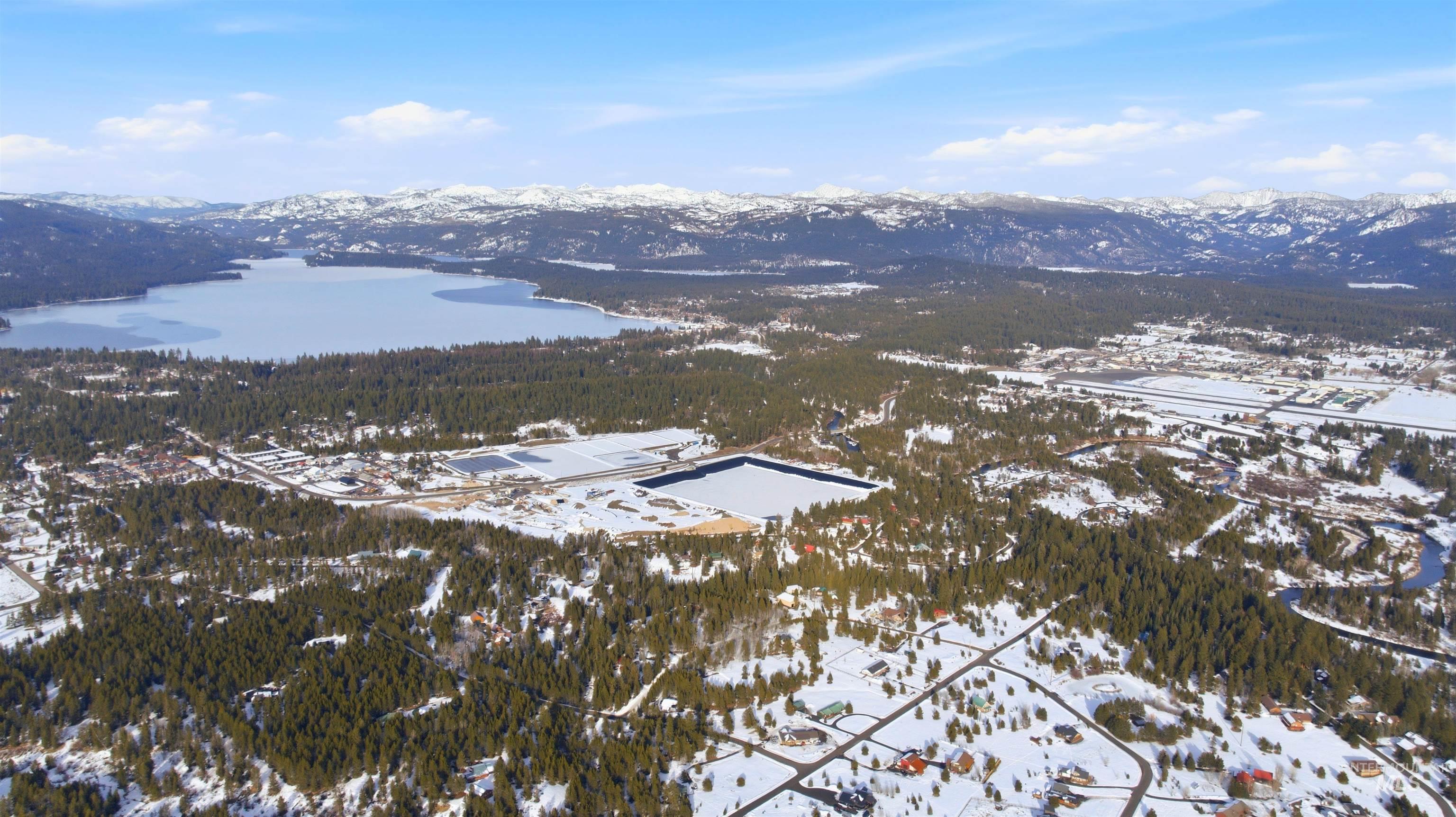 969 Valley View Lane McCall, ID 83638 - Photo 8 of 13 Snowy aerial view featuring a water and mountain view and a view of trees