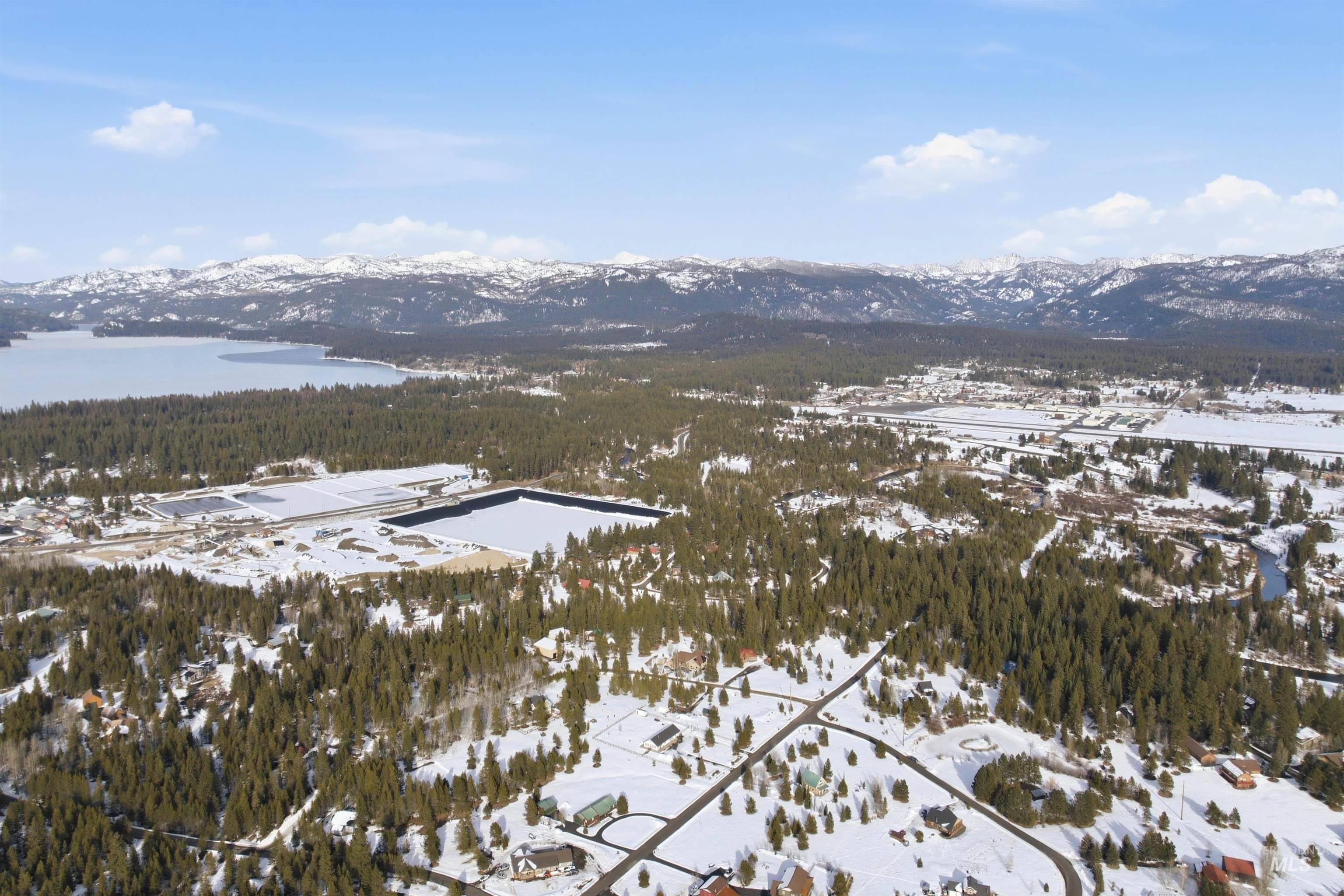 969 Valley View Lane McCall, ID 83638 - Photo 9 of 13 Snowy aerial view featuring a mountain view and a forest view