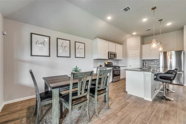 a view of a dining room with furniture and wooden floor