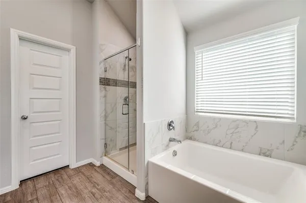 a bathroom with a bathtub and a shower