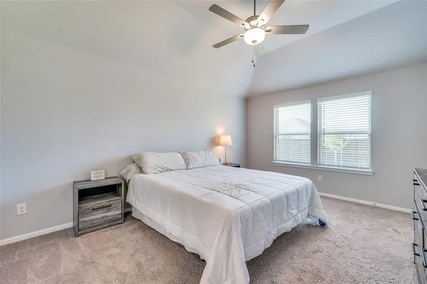a bedroom with a bed and a ceiling fan