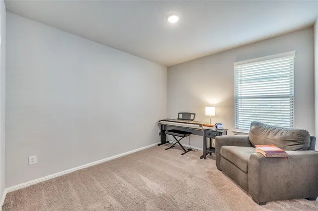a living room with furniture a window and a piano