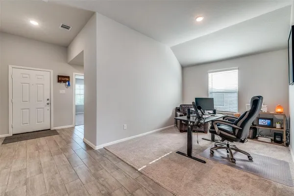 a work room with furniture and wooden floor