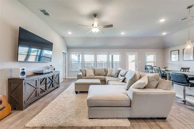 a living room with furniture and a flat screen tv