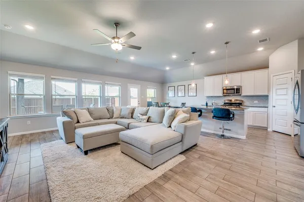 a living room with furniture and a large window
