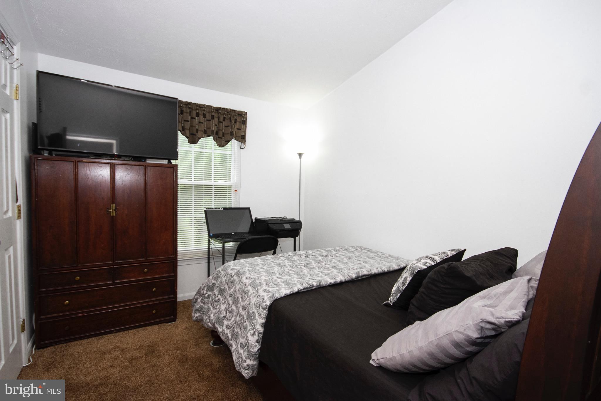 4201 Red Haven Road Baltimore, MD 21208 - Photo 11 of 29 a bedroom with a bed and a television