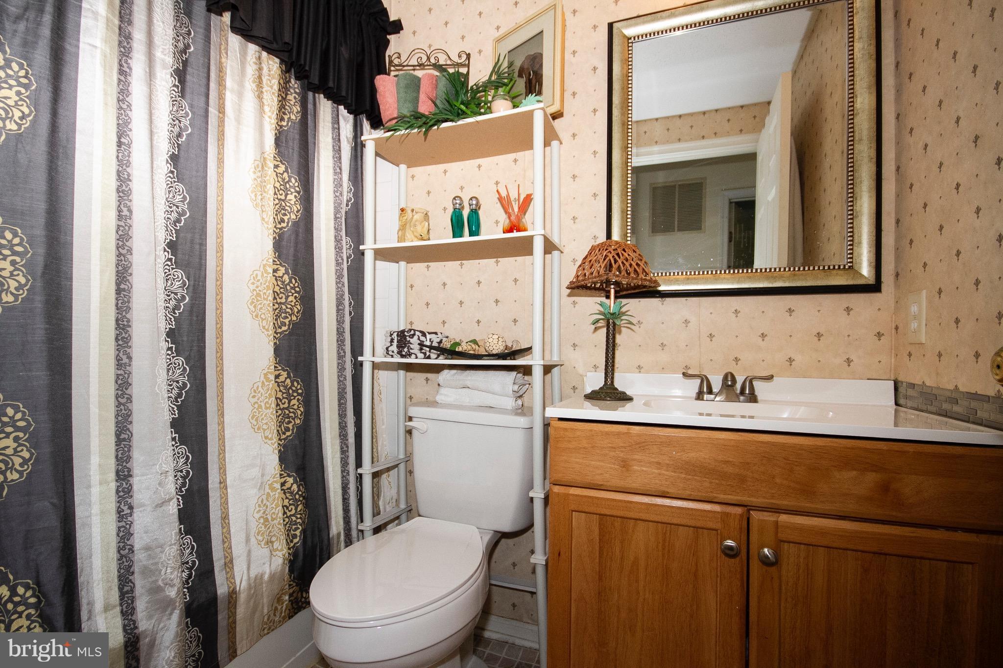 4201 Red Haven Road Baltimore, MD 21208 - Photo 13 of 29 a bathroom with a granite countertop sink toilet and mirror