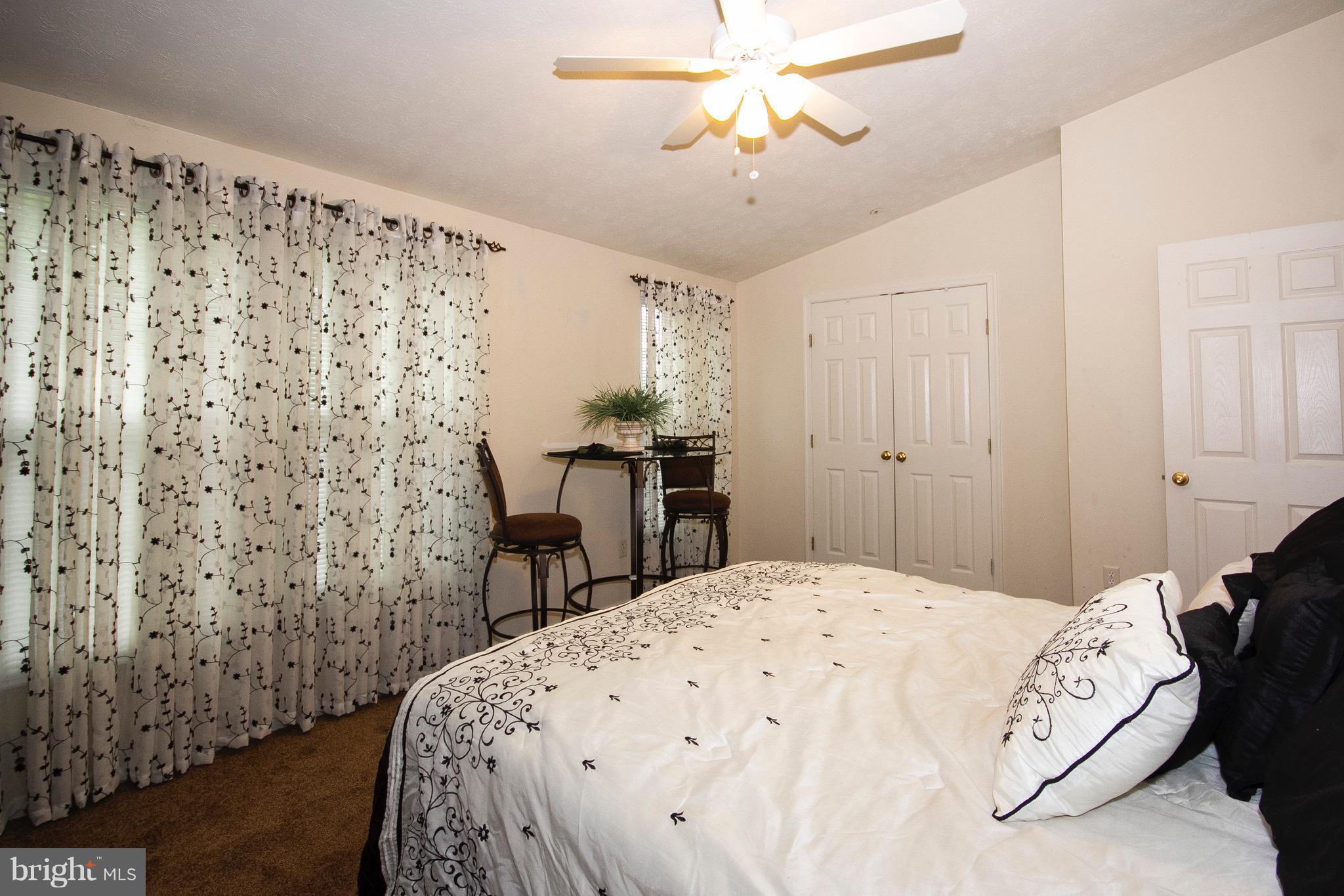 4201 Red Haven Road Baltimore, MD 21208 - Photo 17 of 29 a bedroom with a bed and a chandelier