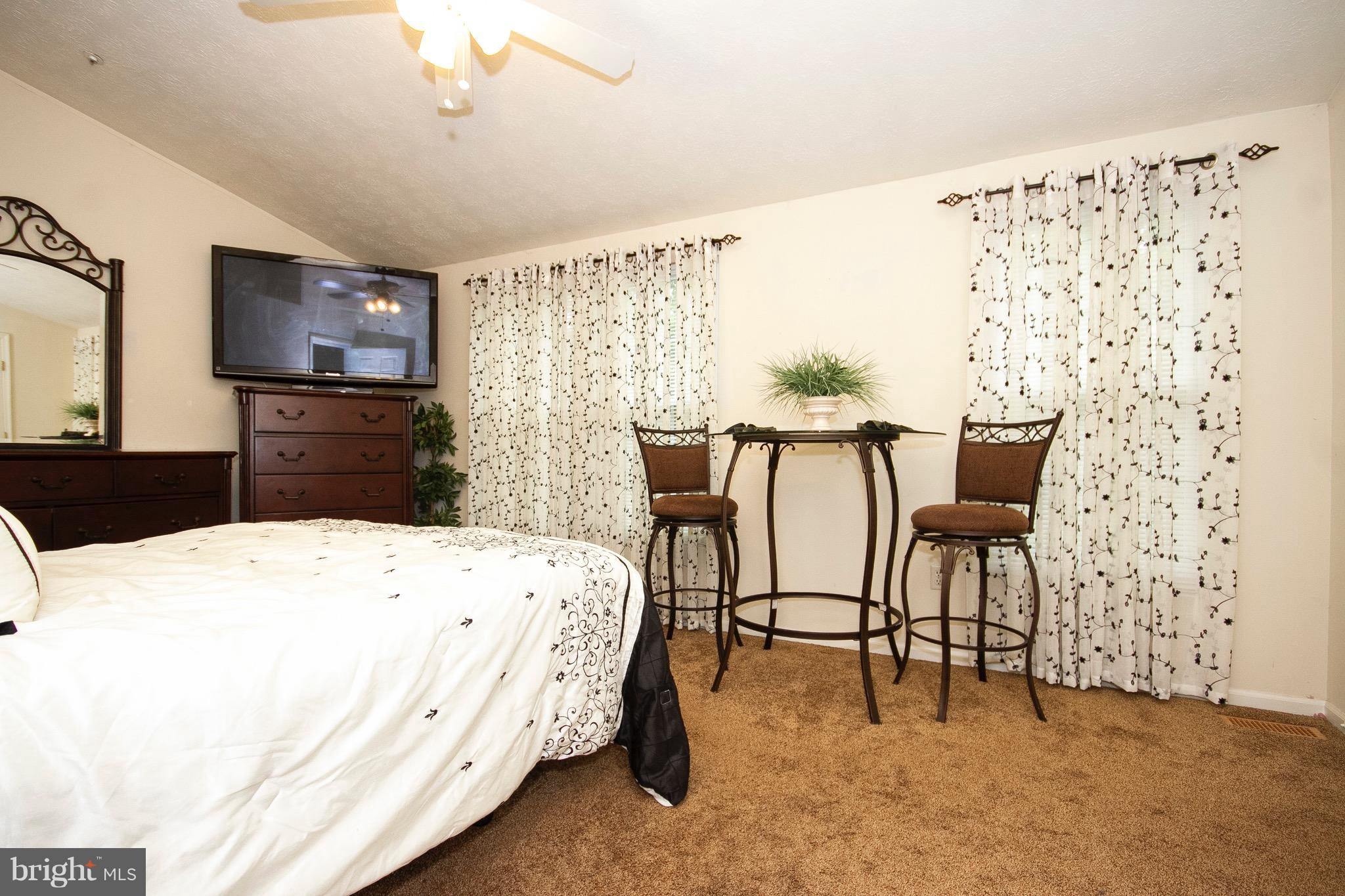 4201 Red Haven Road Baltimore, MD 21208 - Photo 18 of 29 a bedroom with a bed and a table in it