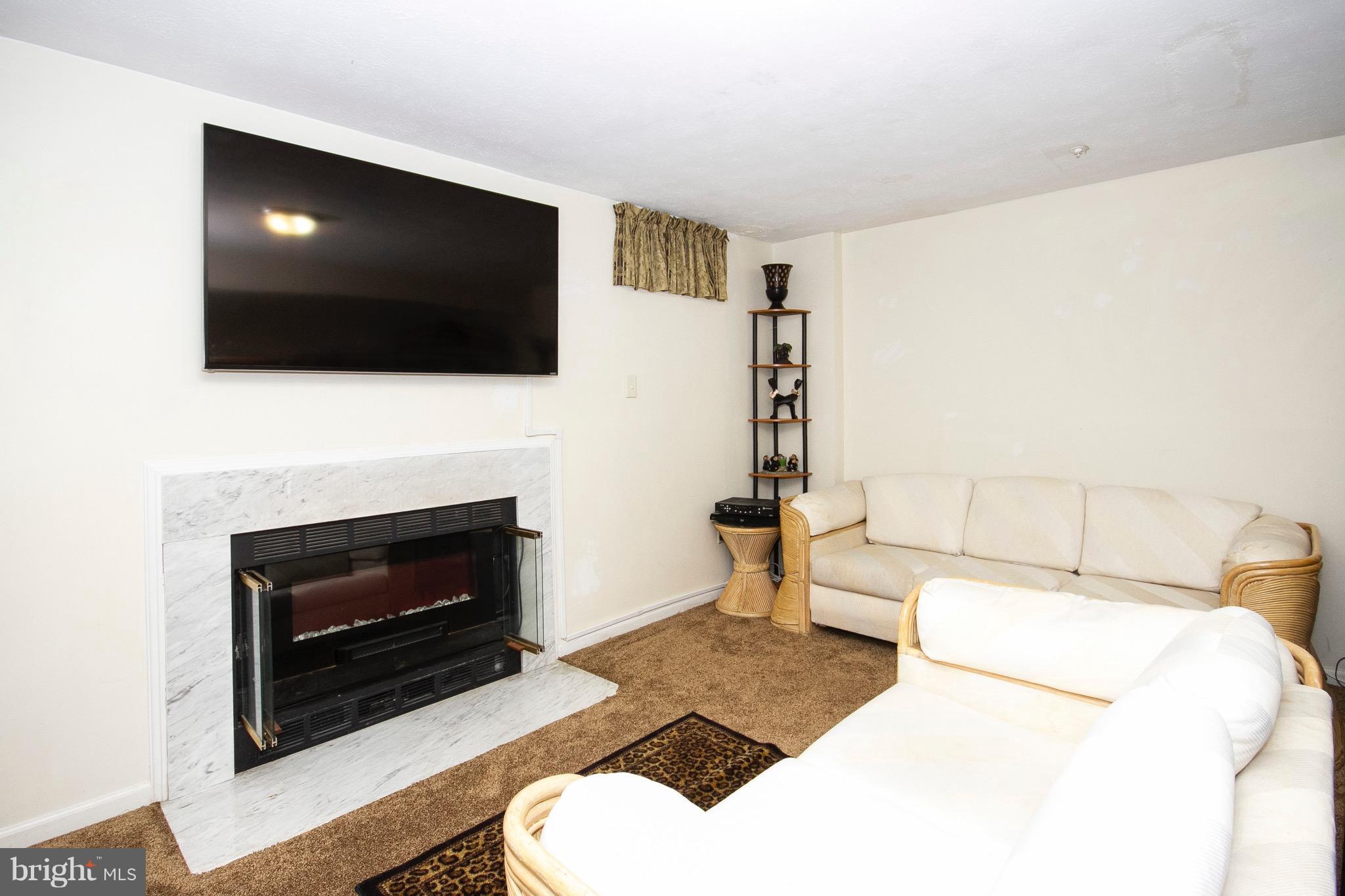 4201 Red Haven Road Baltimore, MD 21208 - Photo 23 of 29 a living room with furniture a flat screen tv and a fireplace
