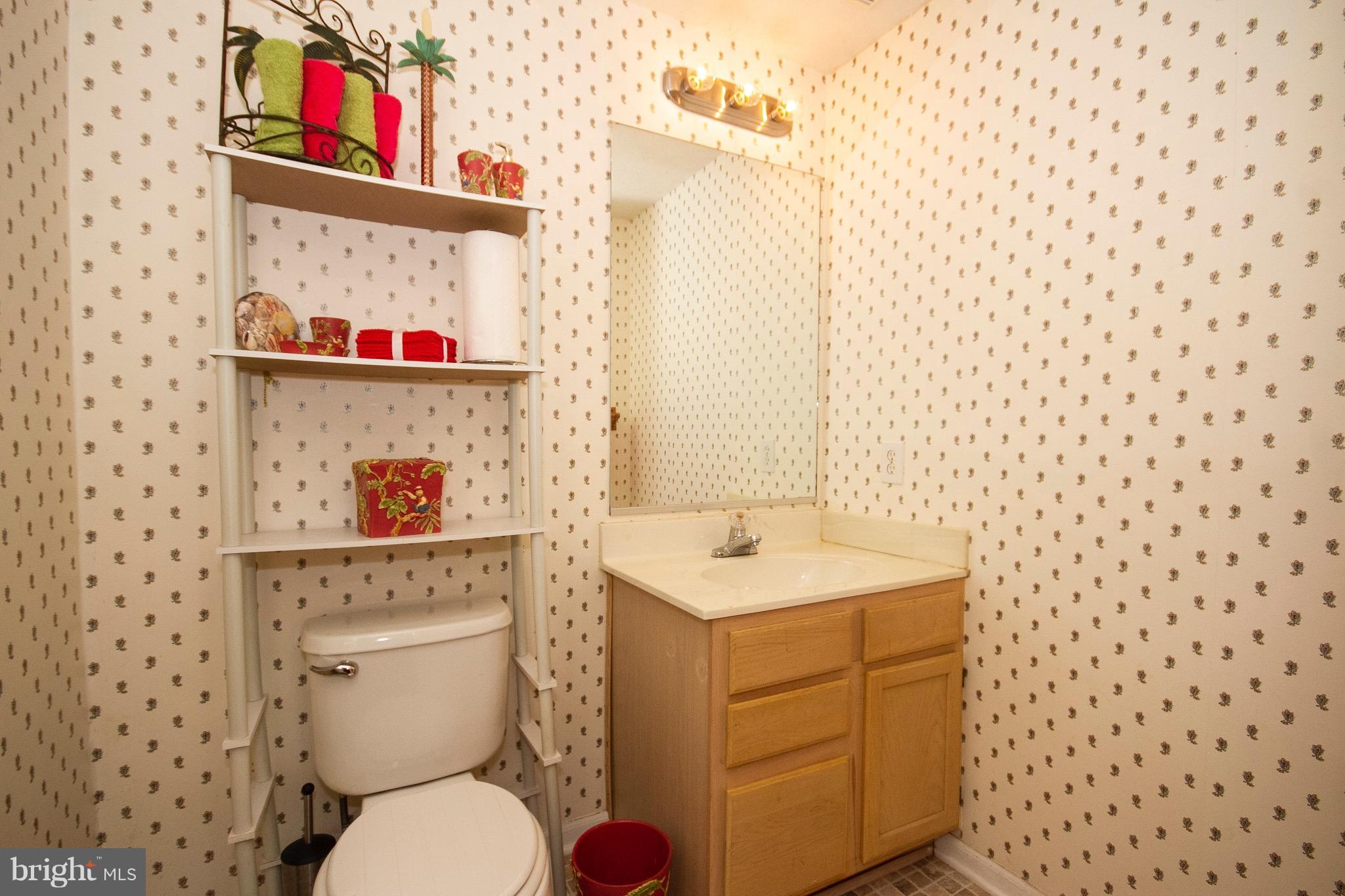 4201 Red Haven Road Baltimore, MD 21208 - Photo 24 of 29 a bathroom with a toilet sink vanity and mirror