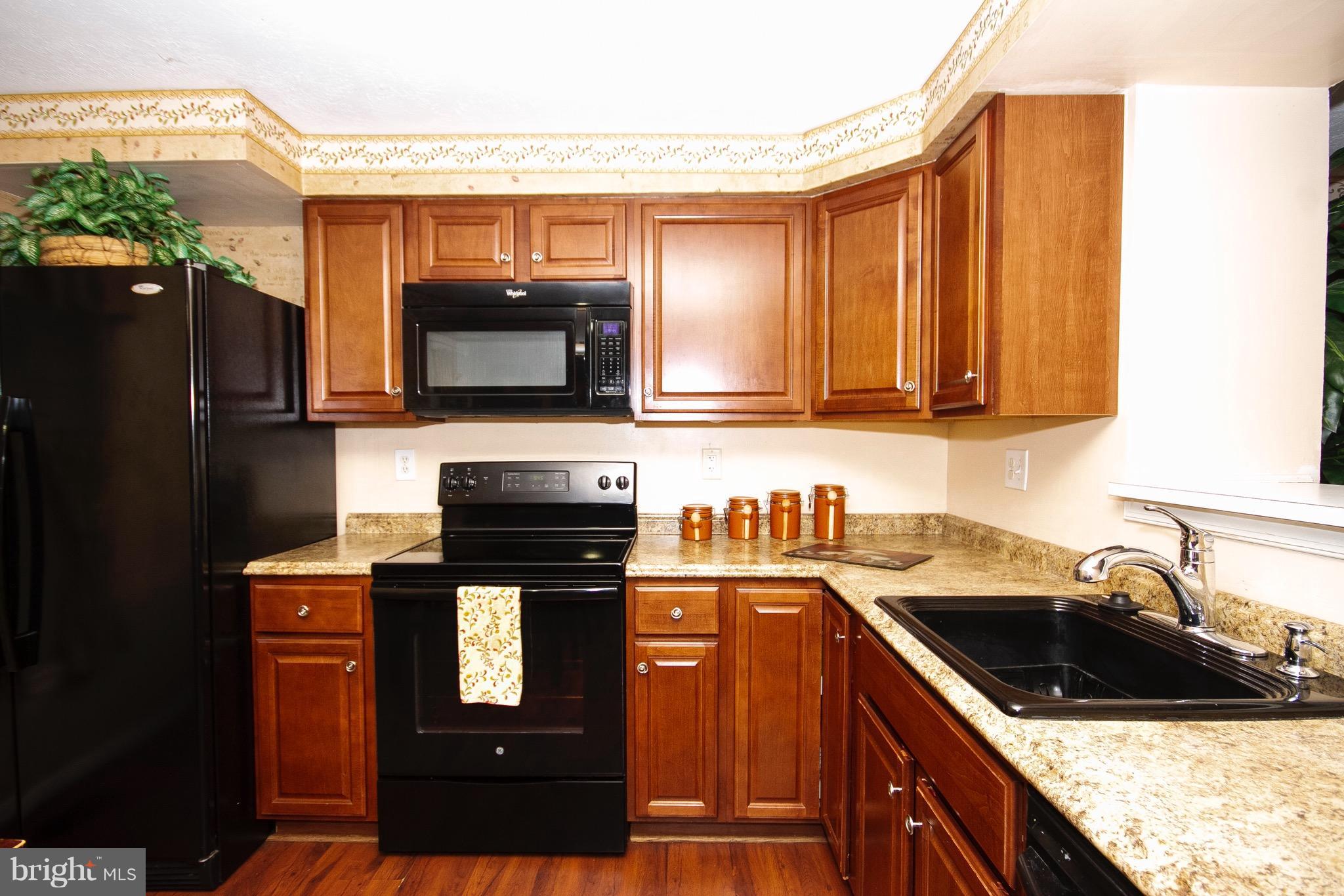 4201 Red Haven Road Baltimore, MD 21208 - Photo 7 of 29 a kitchen with stainless steel appliances granite countertop a stove a sink and a microwave