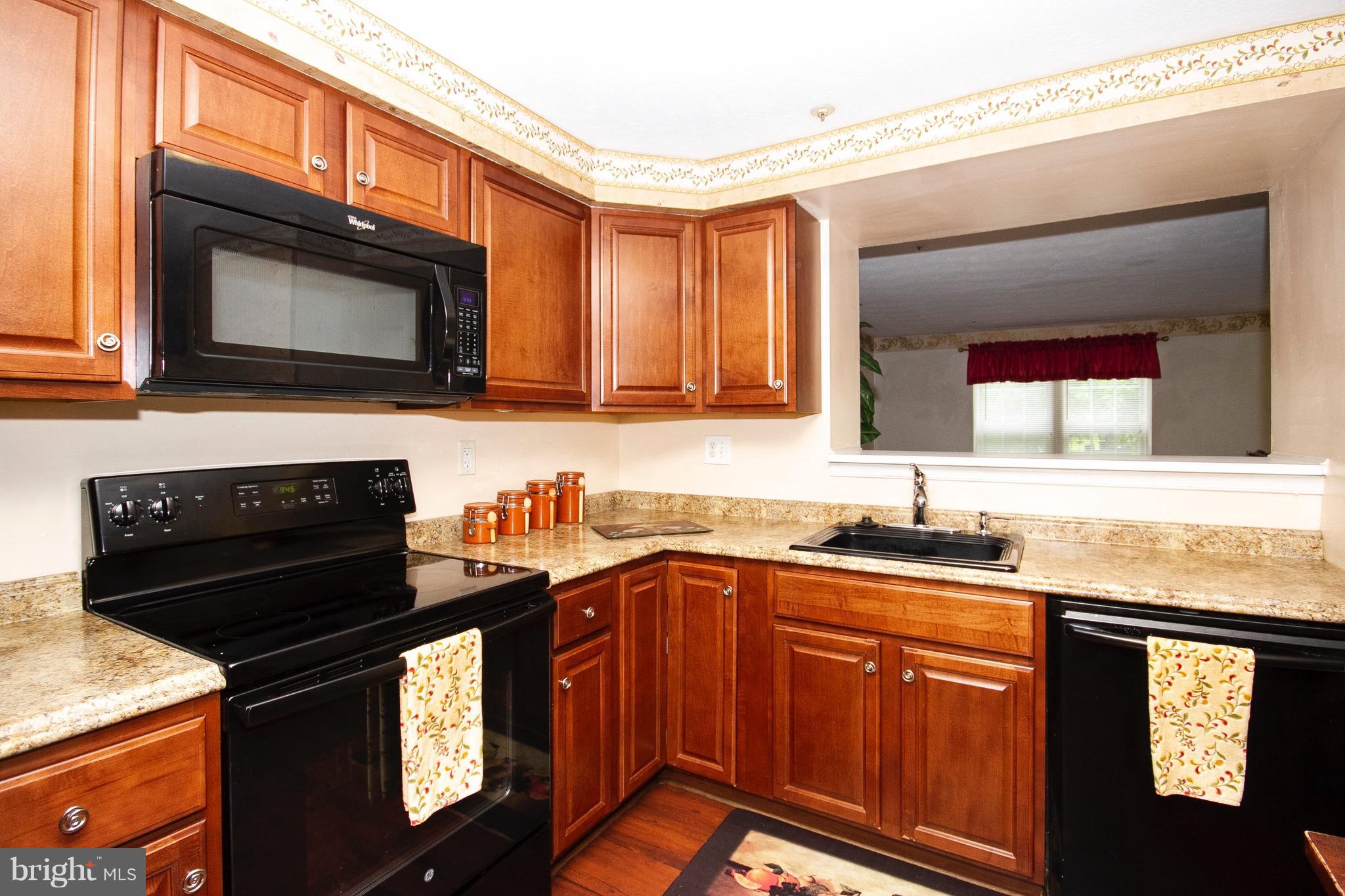 4201 Red Haven Road Baltimore, MD 21208 - Photo 8 of 29 a kitchen with granite countertop a stove sink and cabinets