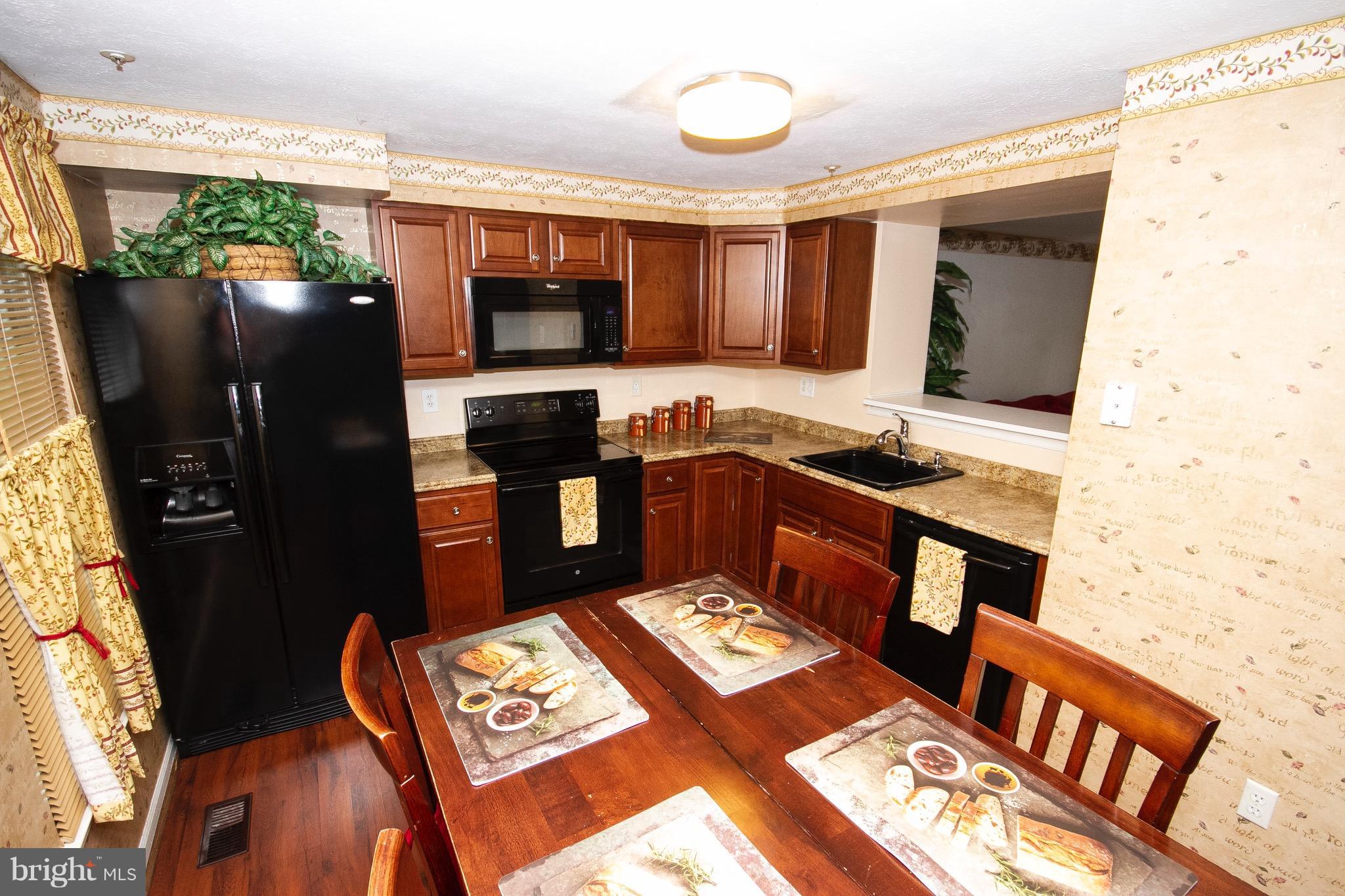 4201 Red Haven Road Baltimore, MD 21208 - Photo 9 of 29 a kitchen with stainless steel appliances granite countertop a refrigerator and a stove top oven