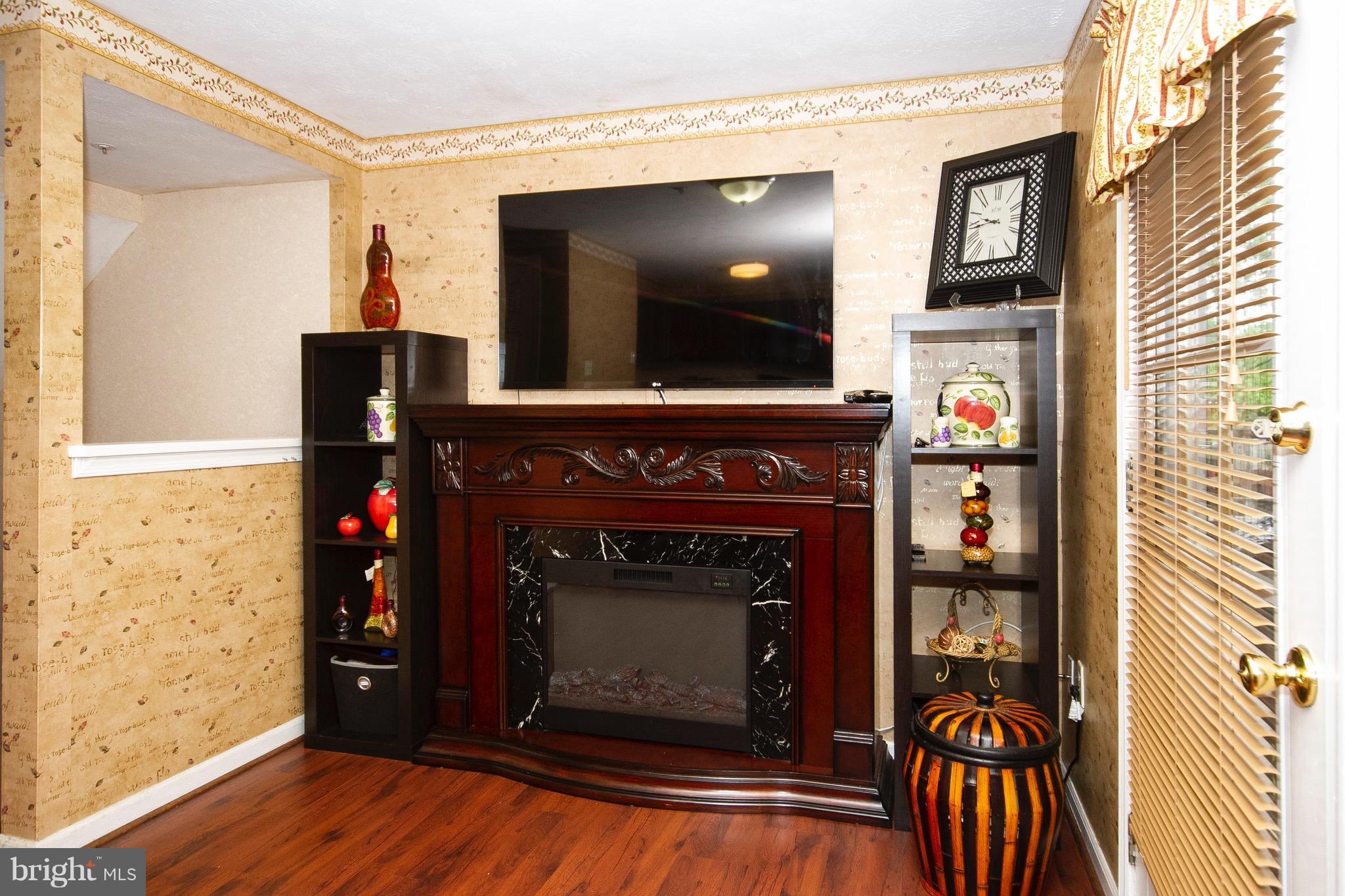 4201 Red Haven Road Baltimore, MD 21208 - Photo 10 of 29 a living room with fireplace and a wooden floor