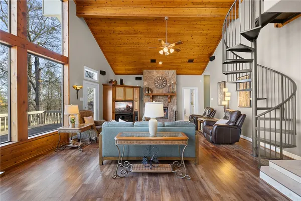 a kitchen with stainless steel appliances granite countertop a refrigerator a stove and a sink with wooden floor
