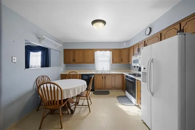 a kitchen with cabinets and refrigerator