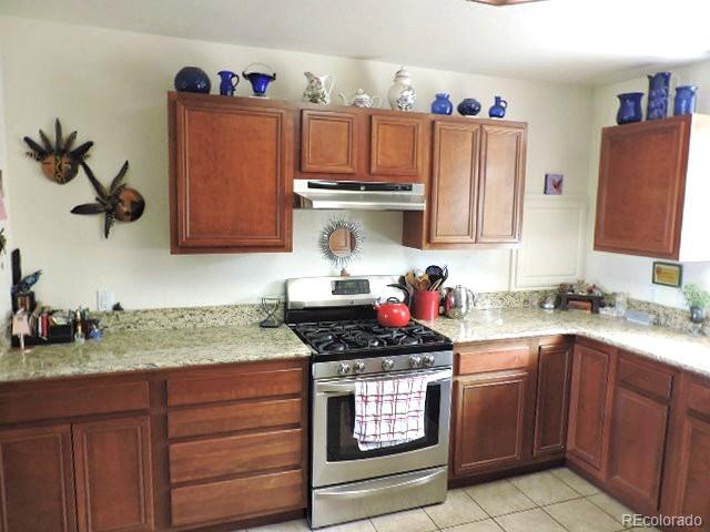 3818 Fontaine Road Fort Garland, CO 81133 - Photo 12 of 50 a kitchen with a stove and cabinets