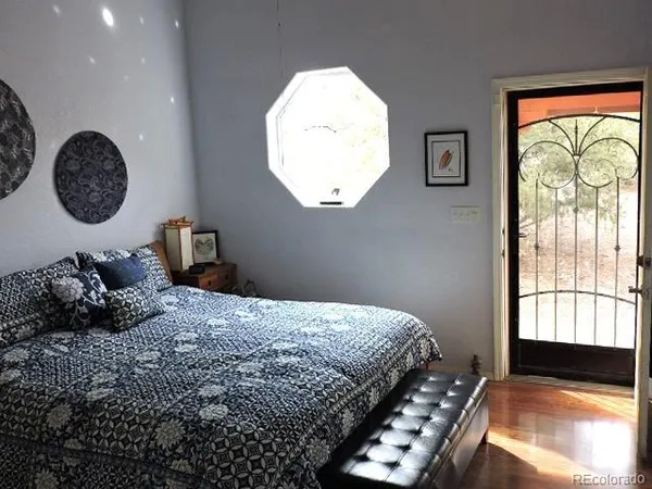 a bedroom with a bed and a chandelier