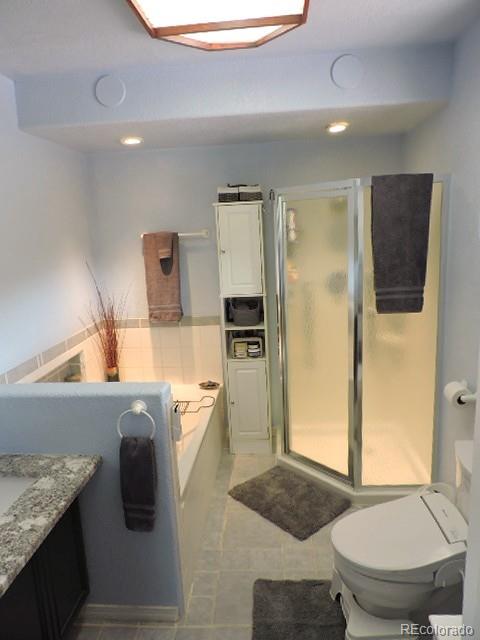 3818 Fontaine Road Fort Garland, CO 81133 - Photo 17 of 50 a spacious bathroom with a granite countertop sink and a mirror