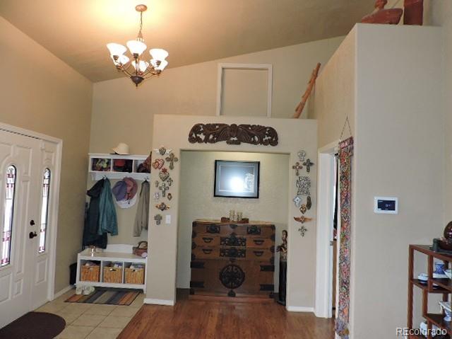 3818 Fontaine Road Fort Garland, CO 81133 - Photo 5 of 50 a view of a livingroom with furniture cabinet flat screen tv and entryway