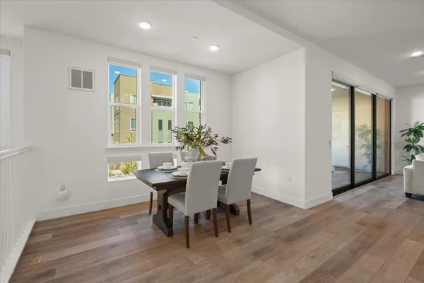 a view of a dining room with furniture and wooden floor