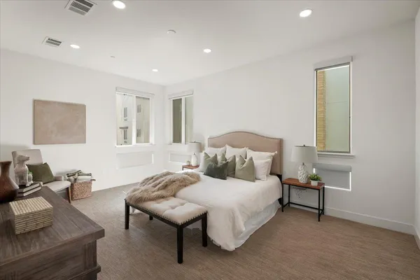 a bedroom with a bed and a couch