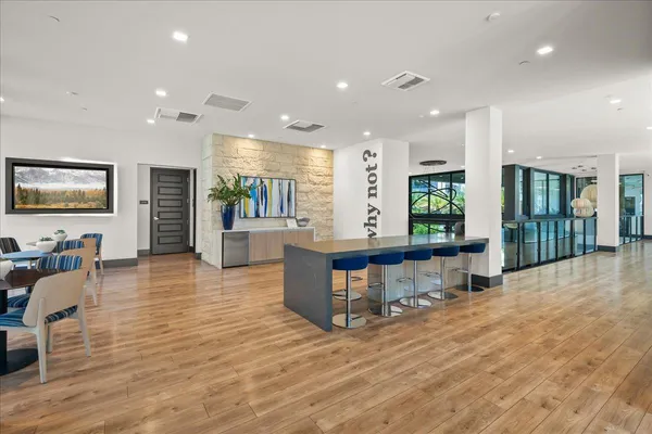 a view of hallway with wooden floor and windows