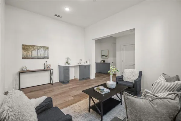 a living room with furniture and wooden floor