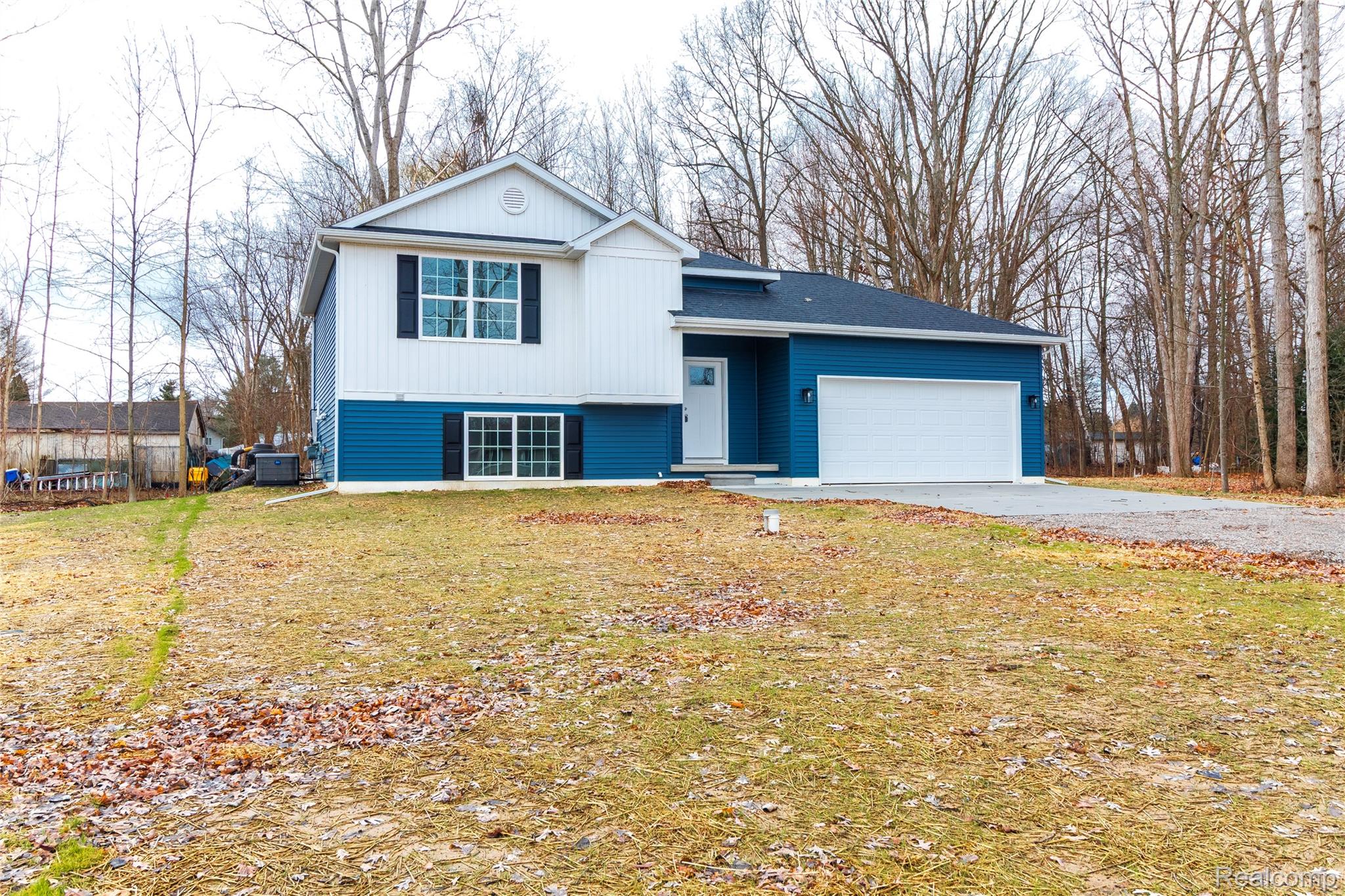 5155 Coldwater Road Lapeer, MI 48446 - Photo 1 of 24 Tri-level home with an attached garage, driveway, and a front yard