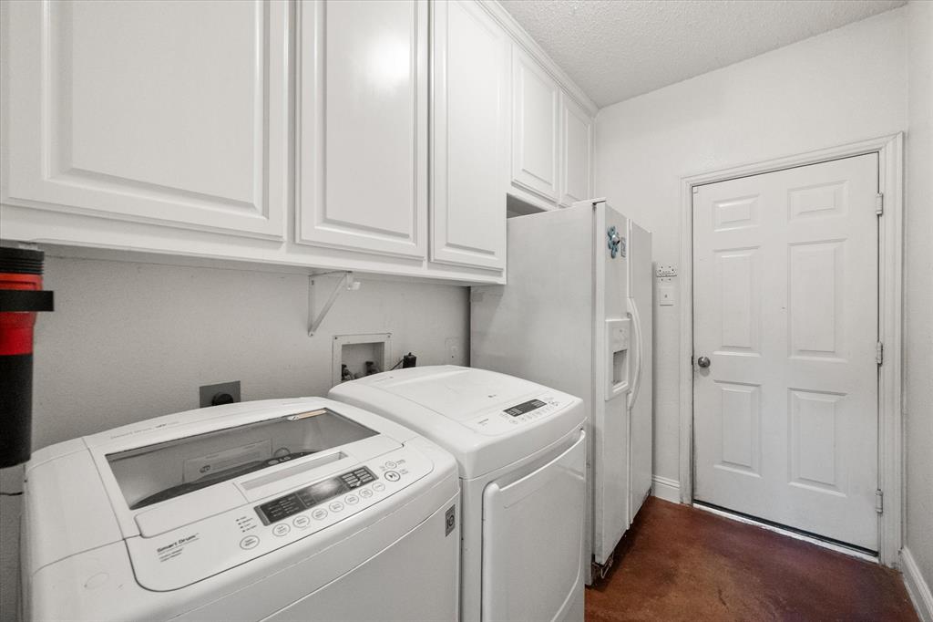 1305 Liverpool Lane Mansfield, TX 76063 - Photo 19 of 40 Utility area featuring white cabinetry, a white refrigerator, and a white door with a silver-toned knob