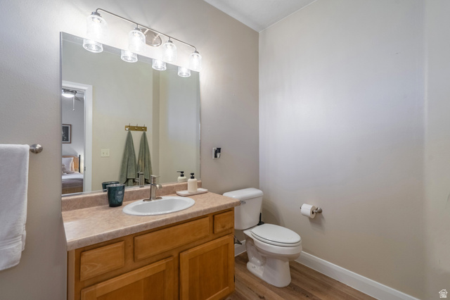 700 North Main Street, Unit F3 Washington, UT 84780 - Photo 18 of 34 Bathroom with wood-finish flooring, a vanity with wood cabinetry, and an integrated sink with a chrome faucet