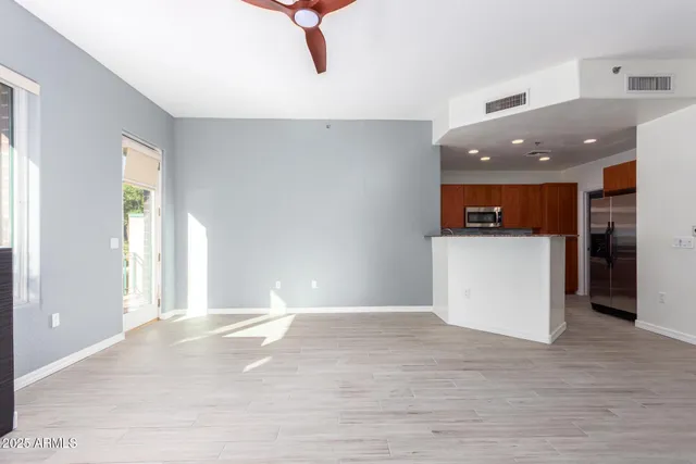 a view of a kitchen with a sink and a refrigerator