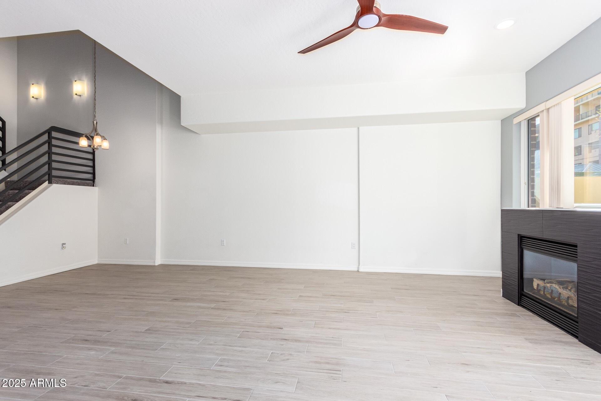 17 West Vernon Avenue, Unit 117 Phoenix, AZ 85003 - Photo 14 of 38 a view of an empty room with wooden floor and a window