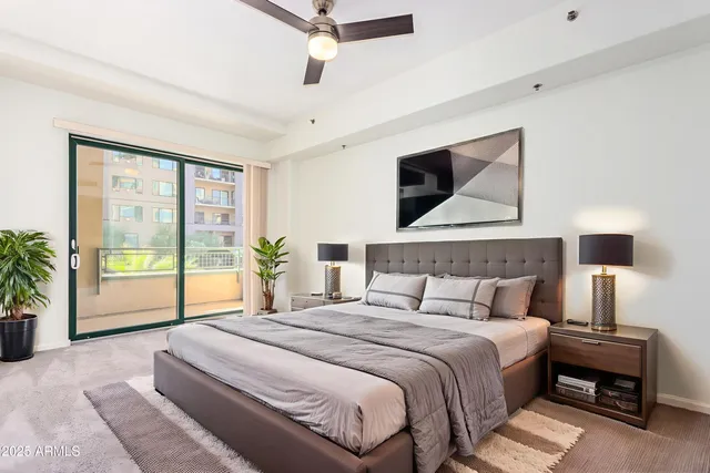 a bedroom with a large bed and a window