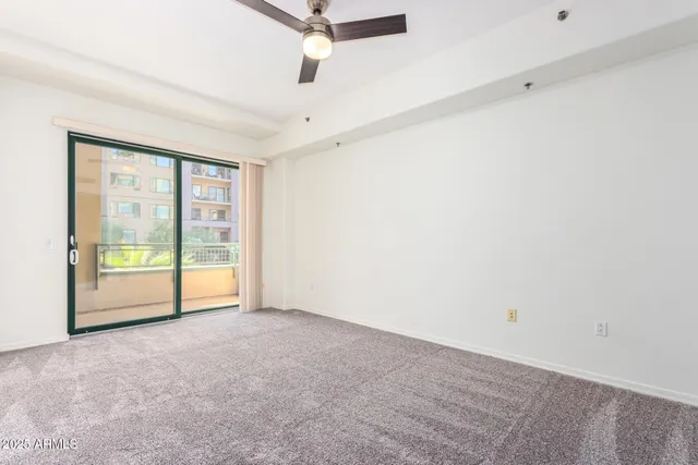 an empty room with sliding glass door and mountain view