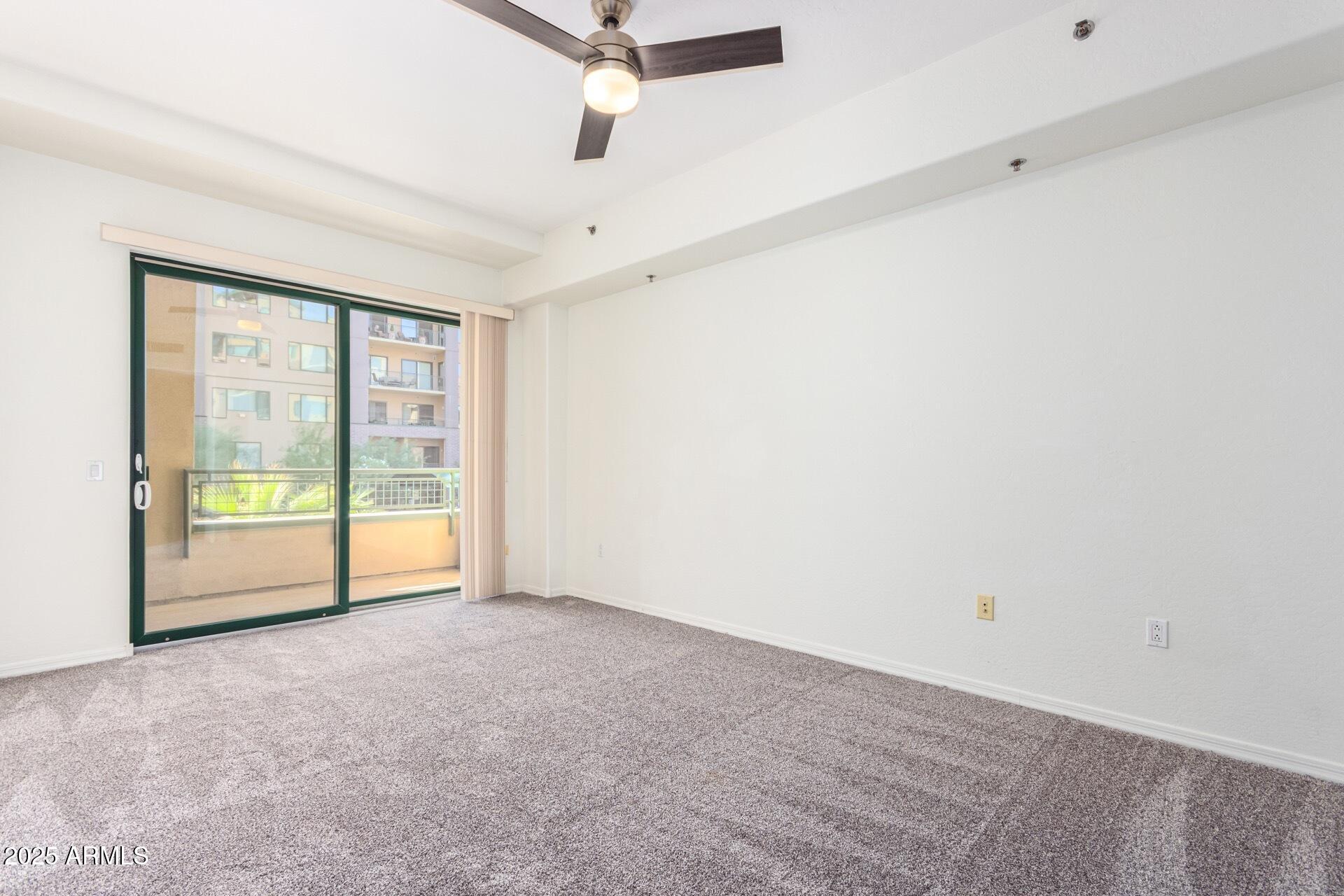 17 West Vernon Avenue, Unit 117 Phoenix, AZ 85003 - Photo 21 of 38 an empty room with sliding glass door and mountain view
