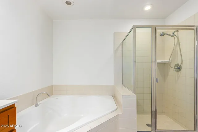 a bathroom with a tub and shower