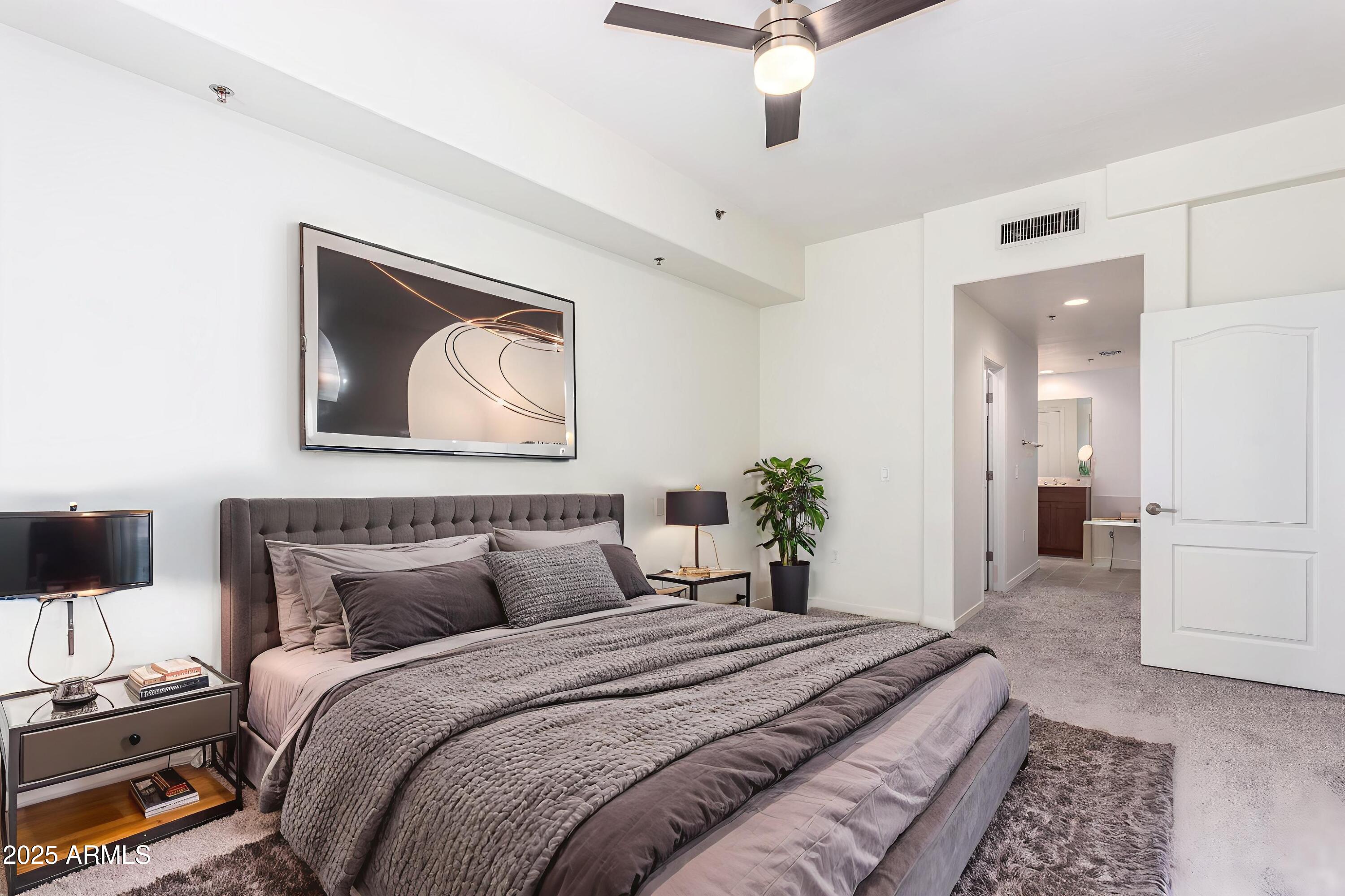 17 West Vernon Avenue, Unit 117 Phoenix, AZ 85003 - Photo 23 of 38 a bedroom with a bed and a painting on the wall