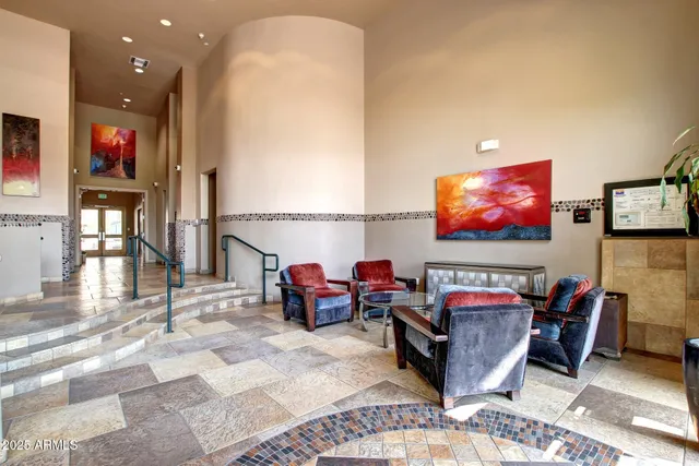 a living room with furniture a flat screen tv and a floor to ceiling window