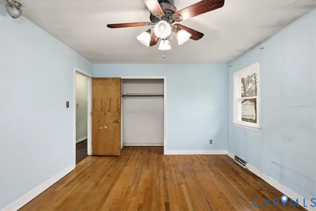 wooden floor in an empty room with a window
