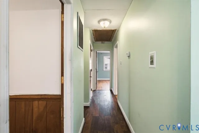 a view of a hallway with wooden floor