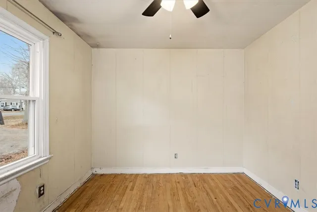 a view of a room with wooden floor and windows