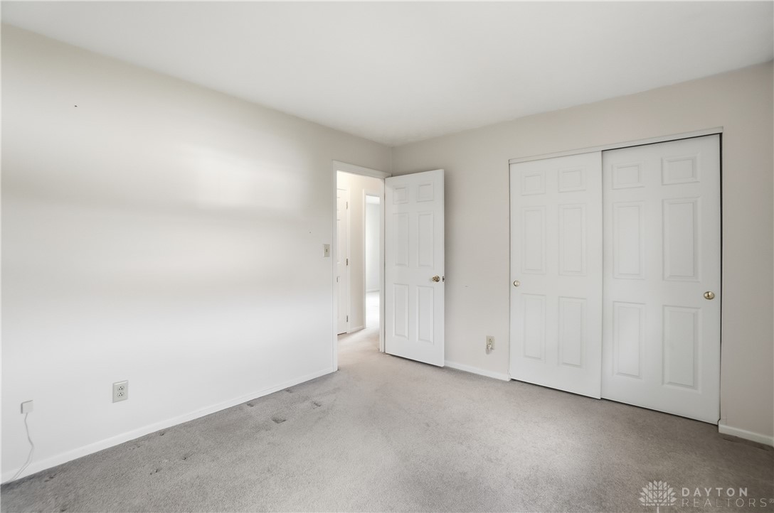 9964 Hummingbird Way Dayton, OH 45458 - Photo 41 of 57 This spacious bedroom offers ample natural light and a neutral palette, awaiting your personal touch.